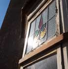 Stained glass header window in the front bay